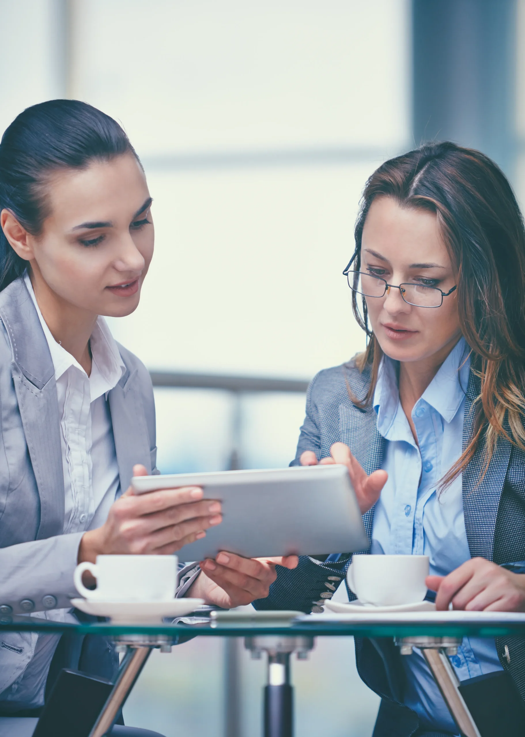 Two business professionals reviewing contract details on a tablet to evaluate a secure eSignature platform.
